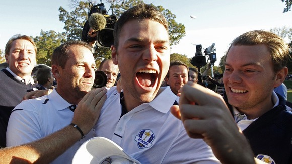 Team Europe golfer Kaymer celebrates winning his match against U.S. golfer Stricker
