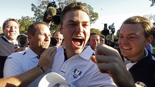 Team Europe golfer Kaymer celebrates winning his match against U.S. golfer Stricker