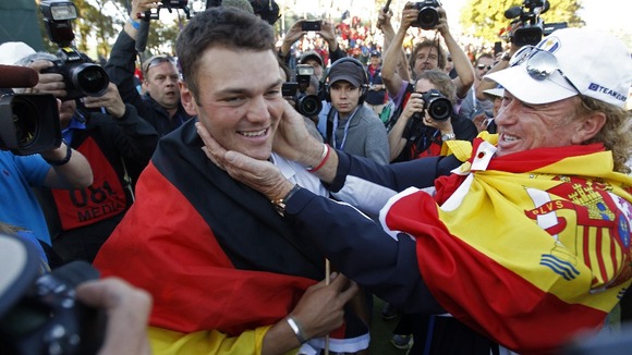 Kaymer celebrates winning his match against U.S. golfer Stricker to retain the Ryder Cup for Europe