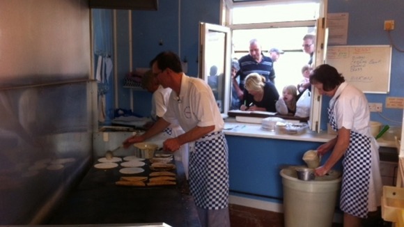 Owner cooking traditional oatcakes in the shop