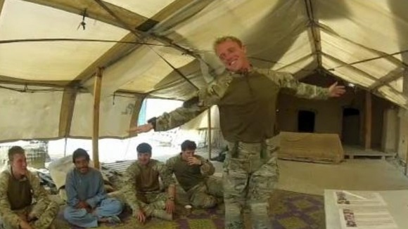 A British soldier dances to the beat of an Afghan drum