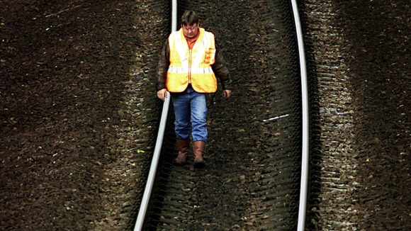 An engineer checks part of the West Coast train line.
