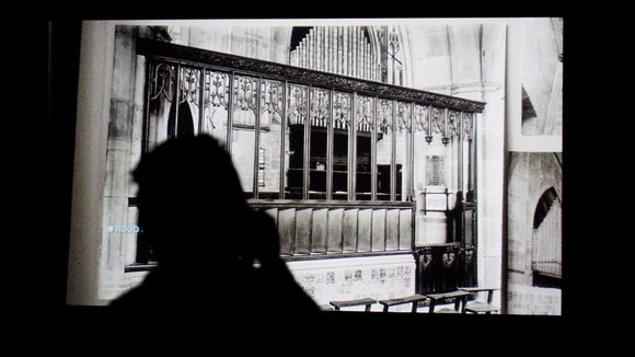 A member of the public watches a video installation entitled 'The Woolworths Choir of 1979 2012' by Elizabeth Price.