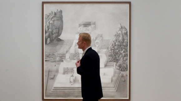 A member of the public walks past a large scale drawing by Paul Noble who is shortlisted for the 2012 Turner prize at Tate Britain.