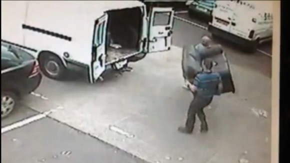 2 men attempt to load a stolen sofa into a van