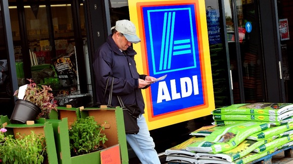 A customer walks out of an Aldi supermarket store in South Derbyshire.
